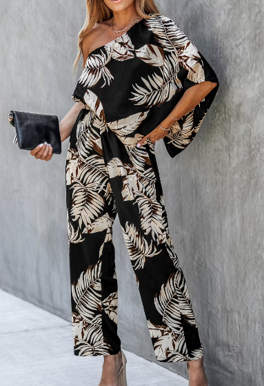 Image: Black jumpsuits with sleeves: Tropical leaf print, one-should jumpsuit Black jumpsuits with sleeves: Tropical leaf print, one-should jumpsuit