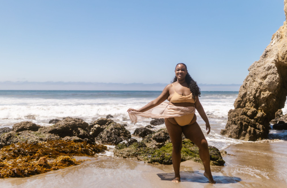 Plus-size swimming costume (UK): A plus-size model wearing a bikini by the sea