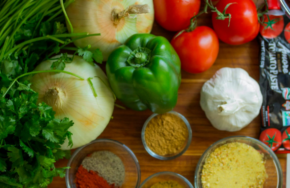 Best ways to save money on food: Grocery items placed on top of a kitchen table.