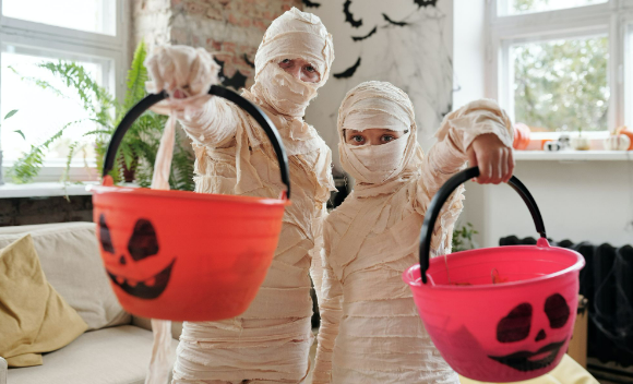Two kids wearing Halloween cheap costumes to celebrate Halloween.