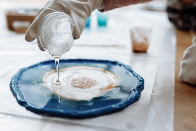 Resin starter kit: An artist pouring clear epoxy resin into a geode mould