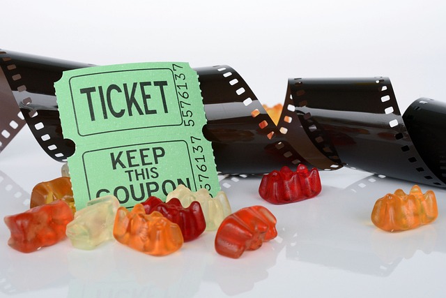 Image: Discount theatre tickets coupon with sweets and film roll in the background Discount theatre tickets coupon with sweets and film roll in the background