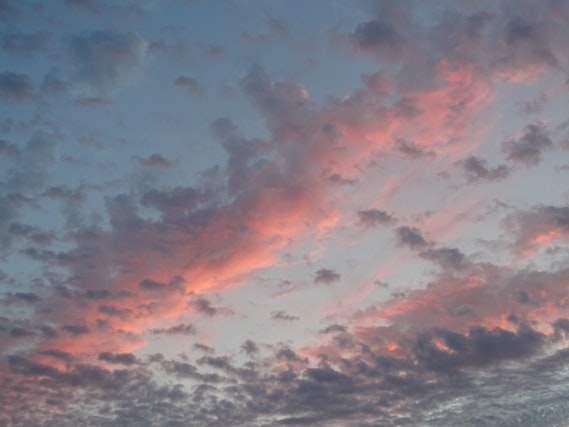 Image: Cloud pink price: A blue cloudy sky at sunset filled with pink and grey clouds Cloud pink price: A blue cloudy sky at sunset filled with pink and grey clouds