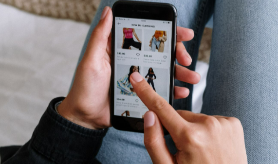 A person shopping the Monsoon sale online via their smartphone