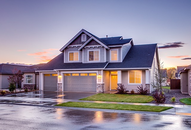 Image: Saving for a house: Beautiful double-storey house with a manicured garden situated on a wet road. Saving for a house: Beautiful double-storey house with a manicured garden situated on a wet road.