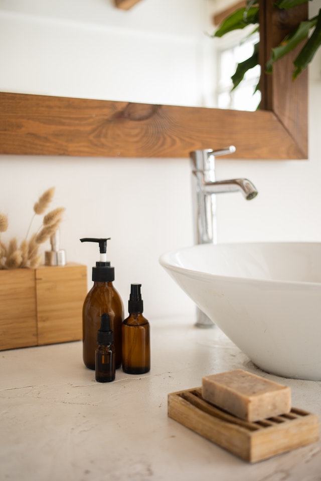 A close-up image of a bathroom vanity with bottles of personal hygiene products