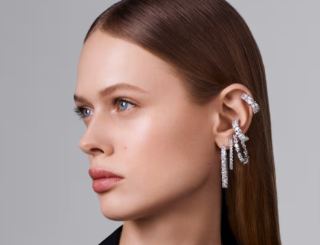 Swarovski Christmas tree earrings: A woman wearing different sets of Swarovski festive earrings