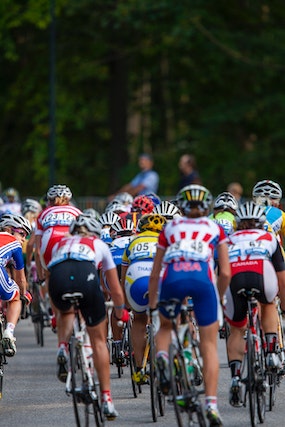 A crowd of Tour De France 2023 riders racing as they head into the countryside
