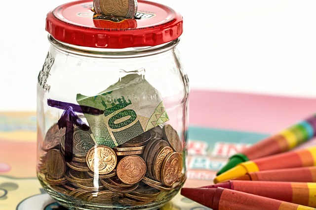 Glass jar filled with coins for best kid’s savings account.