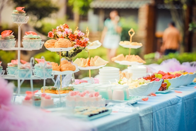 A full English breakfast of different types of food with different textures set on a long table.