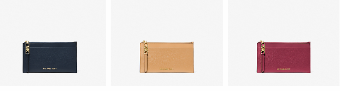 Three different coloured Michael Kors wallet purses for cards.