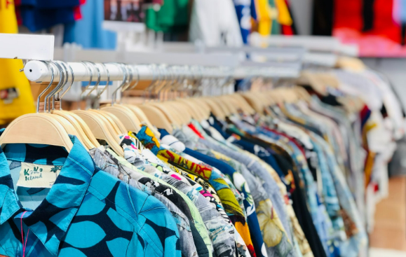 Different types of clothing items hung on display in the Monsoon clothing store.