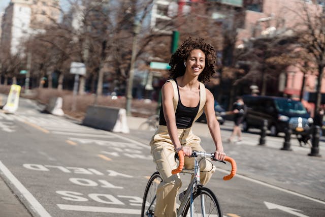 A young woman riding her bicycle to work for Cycle To Work Day