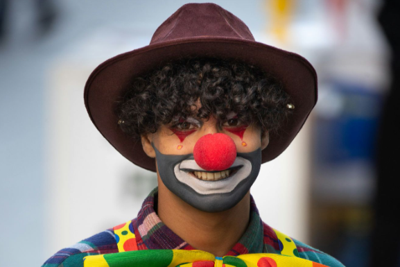 Red Nose Day accessories: A man dressed up as a funny clown with a red nose