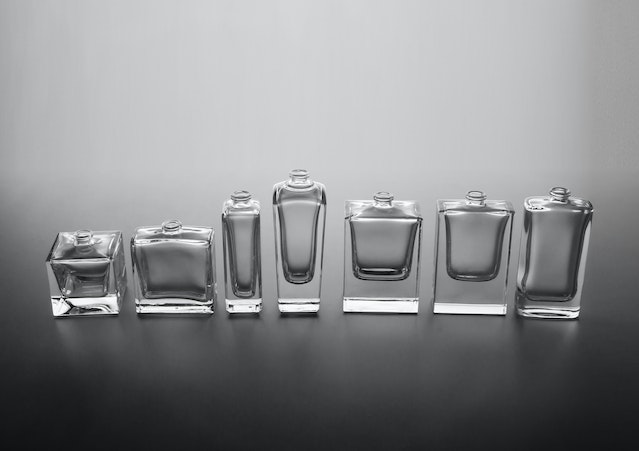 Which is better eau de toilette or eau de parfum: Seven fragrance bottles in various sizes lined up