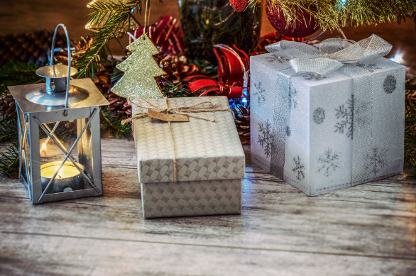 Two cheap presents for Christmas placed under a tree with a lantern.