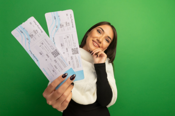 A woman holding two half-price train tickets she bought from the British Rail ticket sales