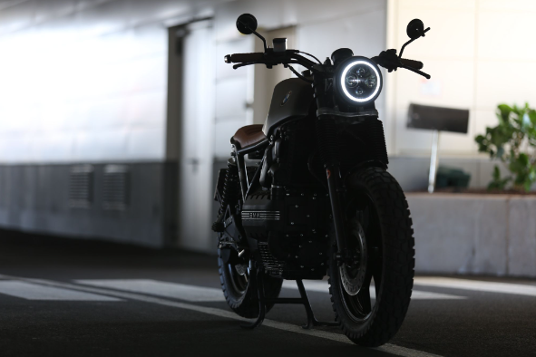 One of the motorcycles on the eBay range is parked in a parking lot.