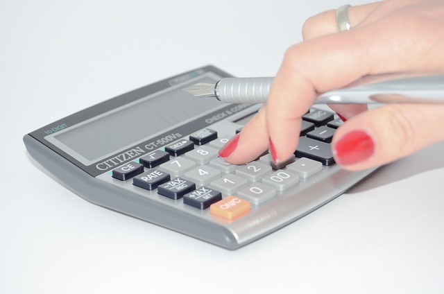 Calculating the average household bills per month using a calculator.