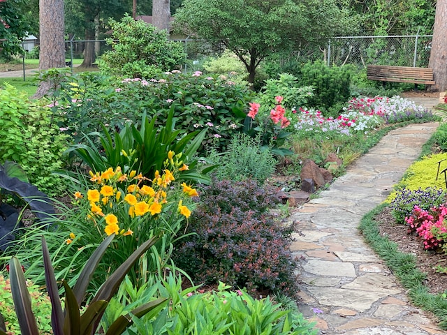 Budget small garden ideas: A garden with various plants, flowers and a stone walkway