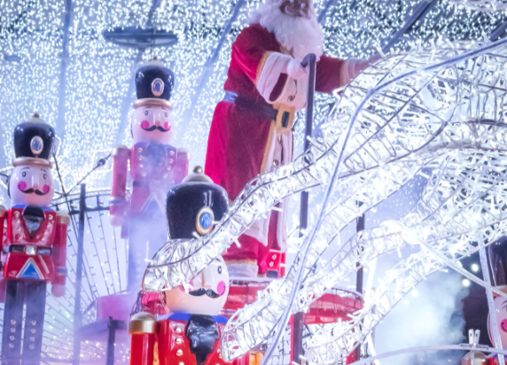 Outdoor Christmas lights and decorations are displayed in the garden.