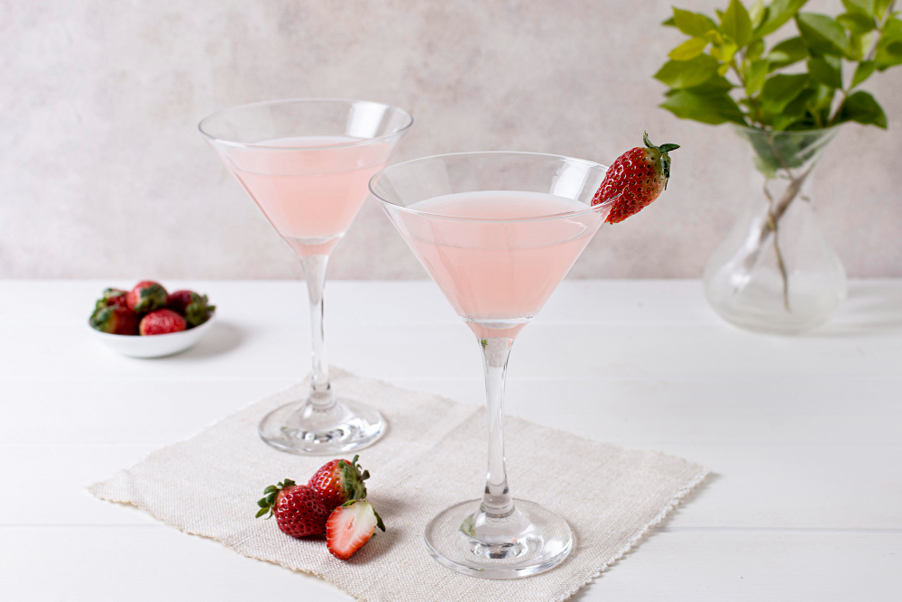 Prosecco Cocktails With Vodka: Pink Prosecco greyhound cocktail on a tea towel with strawberries