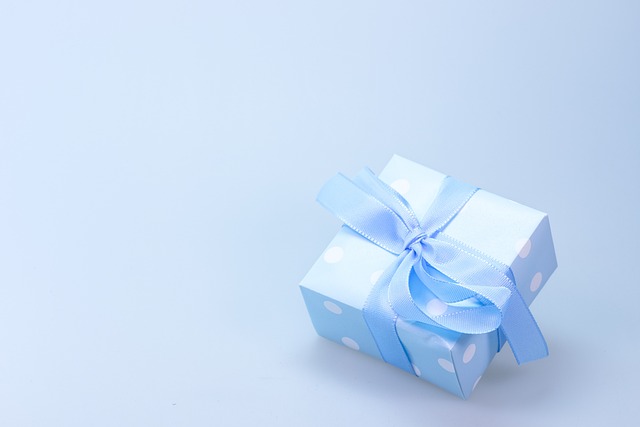 Debenhams women's coats sale:  Powder blue gift box with polka dots and blue ribbon on a blue background.