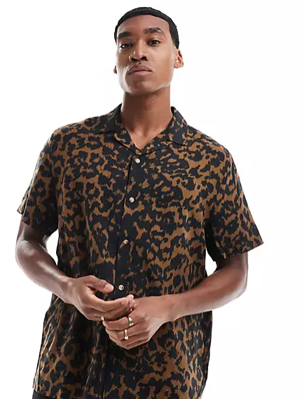 A model wearing the leopard print ASOS DESIGN Relaxed Revere Shirt from ASOS