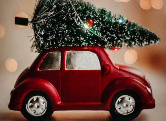 Outdoor Christmas lights and decorations: A miniature car carrying a Christmas tree