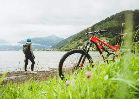 A man taking a break and enjoying the scenery while doing his different electric bike trails.