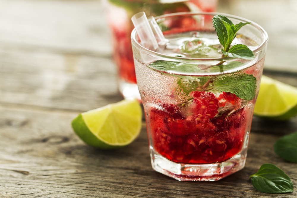 Prosecco cocktails with vodka: Fresh lemon raspberry vodka cocktail on a wooden table