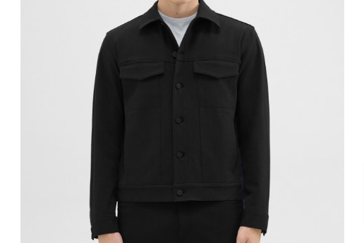 A man wearing the River Trucker jacket from the Theory clothes on sale range
