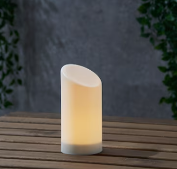 Outdoor Christmas light decorations: LED Block Candle that is placed on a porch outside