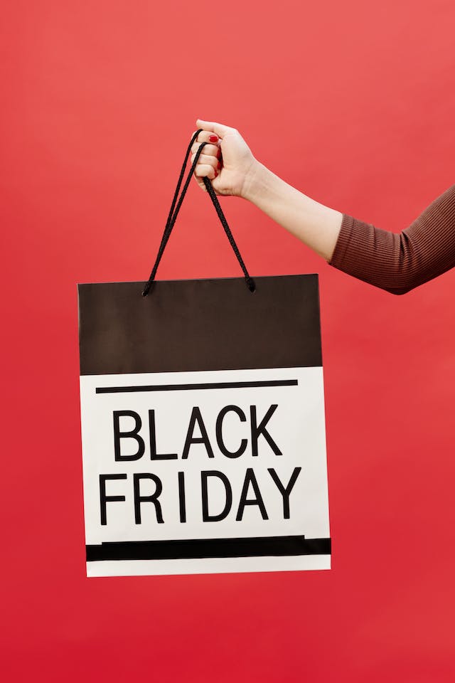How Black Friday got its name: a hand holding a shopping bag with ‘Black Friday’ written on it