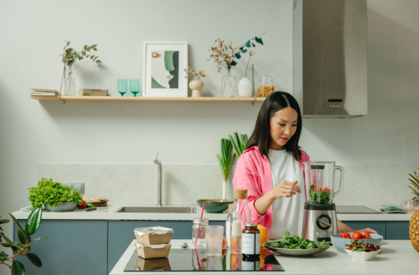 Top-rated home appliances: A woman preparing smoothies with her blender