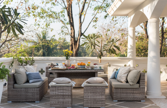 Image: Rattan garden furniture set on patio with pillows and cushions Rattan garden furniture set on patio with pillows and cushions