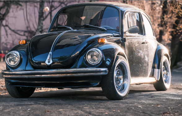 An eBay classic car for sale: A Black Volkswagen beetle car parked on the road