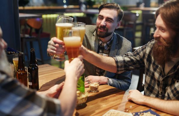 Men celebrating world beer day with beer