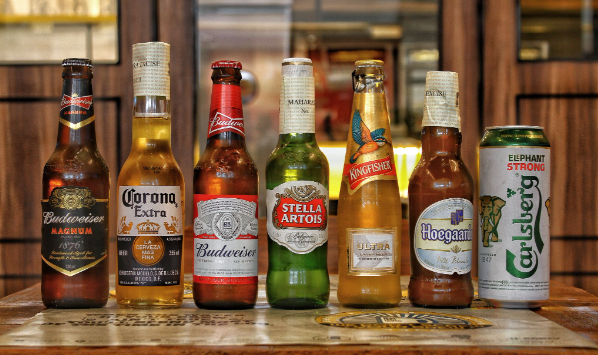Assorted beer bottles arranged in a line on the table for beer day.