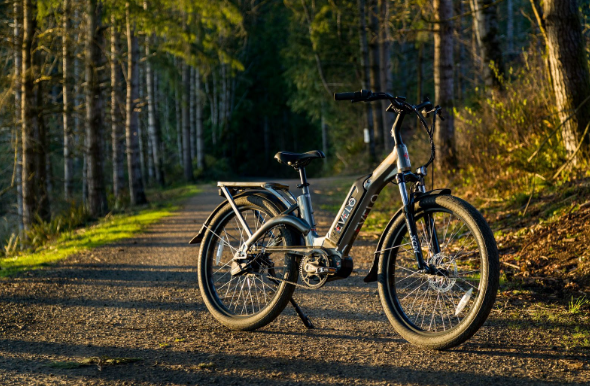 Image: An electric folding bike that is parked on a dirt bike trail An electric folding bike that is parked on a dirt bike trail