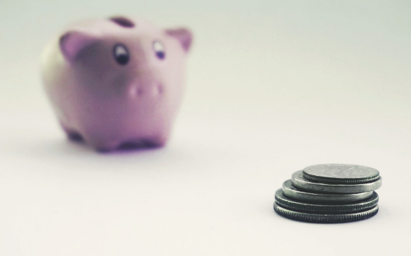 A piggy bank with coins for savings from the Amazon deals of the day.