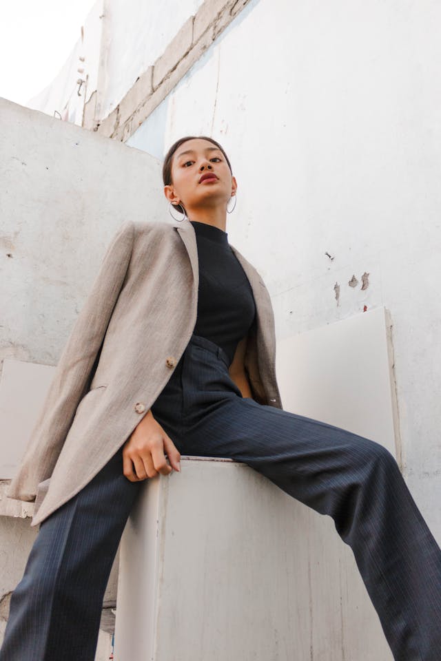Image: A woman in a blazer and high-rise trousers that are part of current trends in women’s fashion A woman in a blazer and high-rise trousers that are part of current trends in women’s fashion