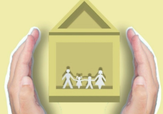 Two hands from local estate agents around a house with a paper family cut out in the middle.