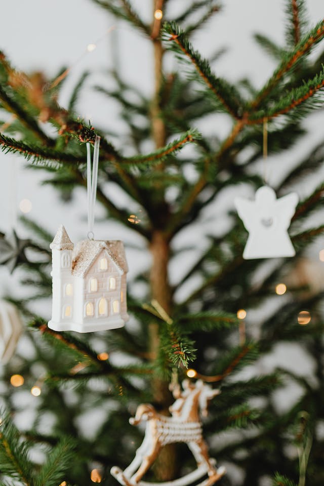 Homemade Christmas tree ornaments hanging on the branches of a real Christmas tree