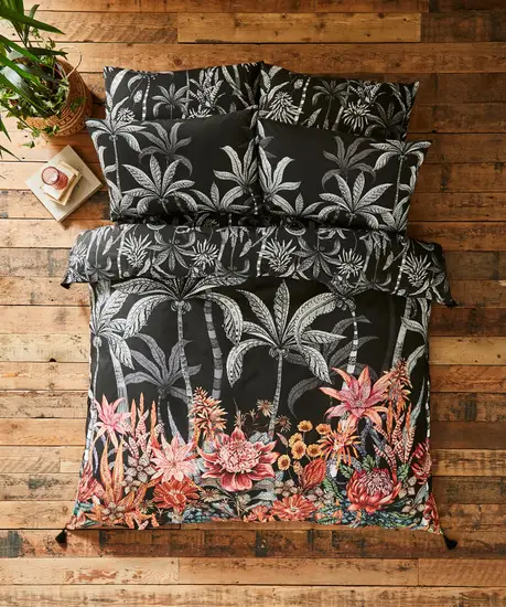 bohemian interior design tips: A top view of a bed clad in floral bedding