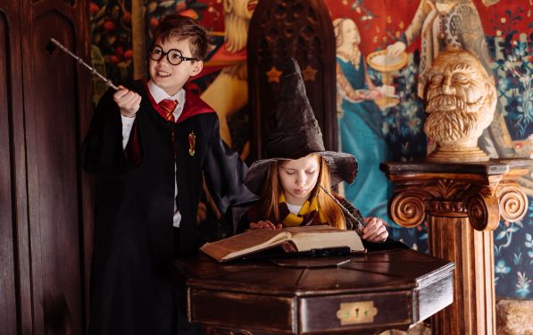 Two children dressed up in unique World Book Day costumes with accessories
