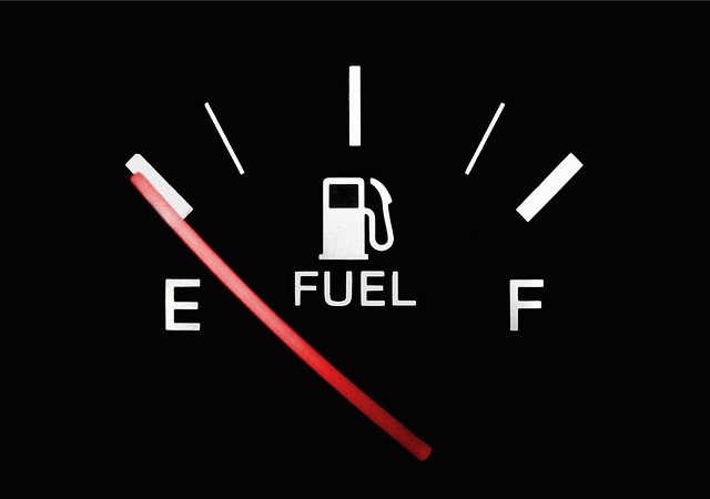 Black fuel gauge with a red pin showing empty