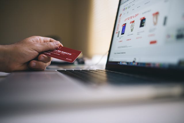 Image: A person with a credit card shopping on their laptop for the best deals on Amazon Prime Day A person with a credit card shopping on their laptop for the best deals on Amazon Prime Day