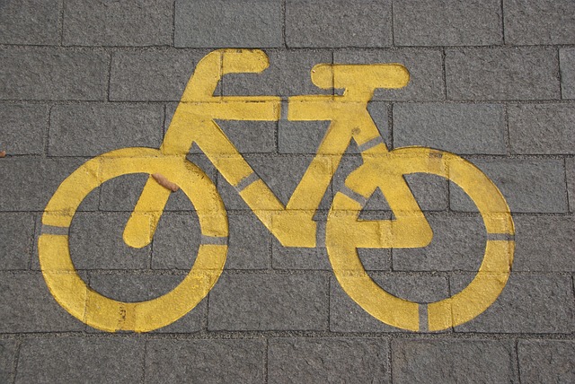 A bicycle traffic lane sign painted in yellow on the ground