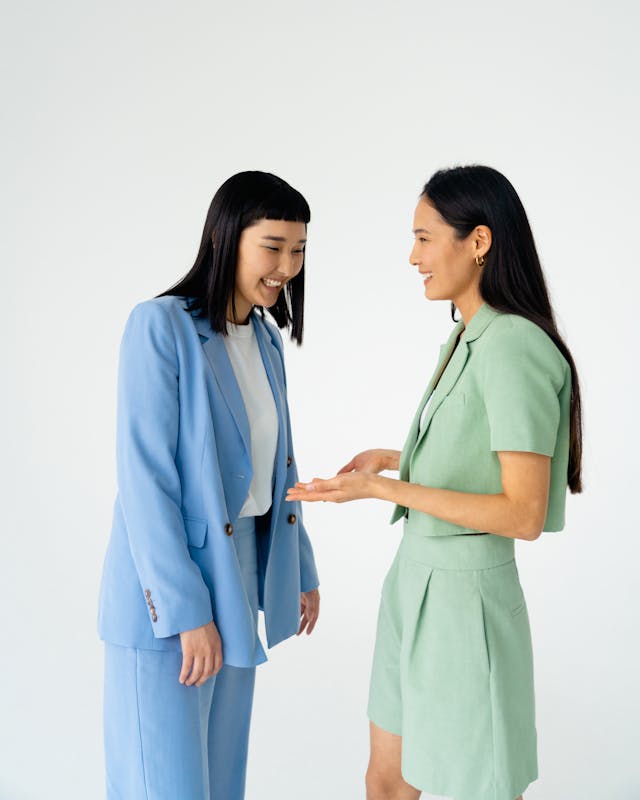 Image: Two women wearing pastel suits from current trends in women’s fashion Two women wearing pastel suits from current trends in women’s fashion